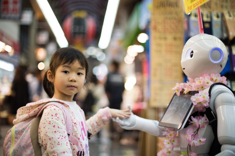 girl holding a robot's hand