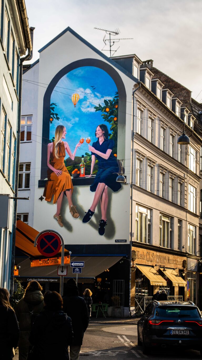 A mural in Copenhagen showing capitalism's idea of what happiness is